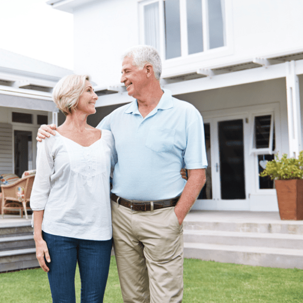 A couple in front of their house