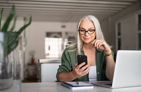 Woman with Laptop and Mobile Phone